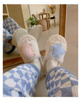 Creamy white fluffy plush home slippers with asymmetrical decorations of cute stars and moons
