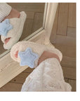Creamy white fluffy plush home slippers with asymmetrical decorations of cute stars and moons