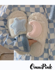 Creamy white fluffy plush home slippers with asymmetrical decorations of cute stars and moons